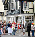 Buy local – buy food and other products from local shops (People in Town Centre, Annual Book Festival, Hay on Wye, Mid Wales)